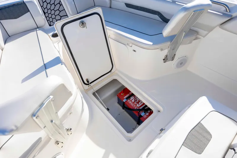 Slide: The Image of 2019 Wellcraft 222 Fisherman boat interior with open storage compartment. - 13
