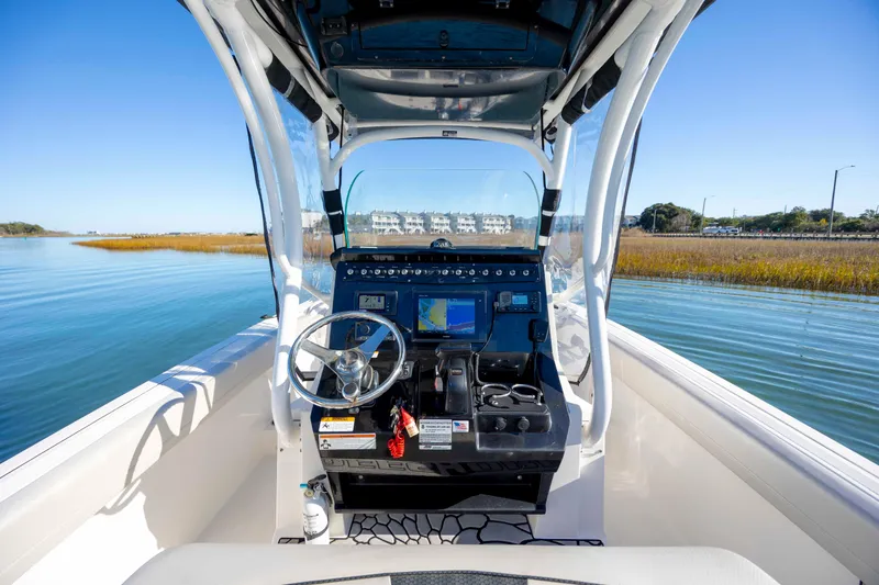 Slide: The Image of 2019 Wellcraft 222 Fisherman boat dashboard with steering wheel and navigation system. - 15