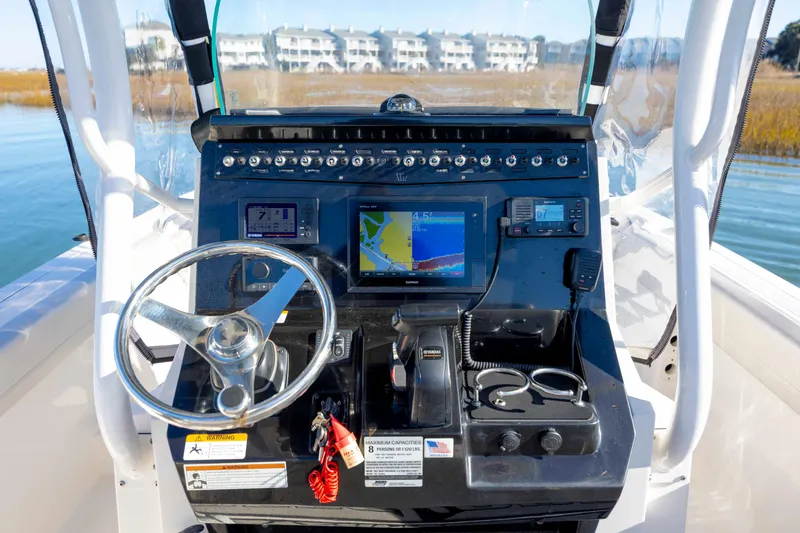 Slide: The Image of Control panel of a 2019 Wellcraft 222 Fisherman boat with navigation equipment. - 16