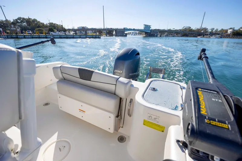 Slide: The Image of 2019 Wellcraft 222 Fisherman boat on water, featuring outboard motor and fishing equipment. - 18