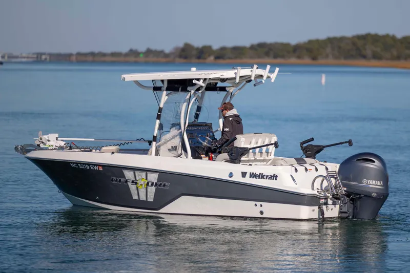Slide: The Image of 2019 Wellcraft 222 Fisherman boat on calm water, featuring Yamaha outboard motor. - 2