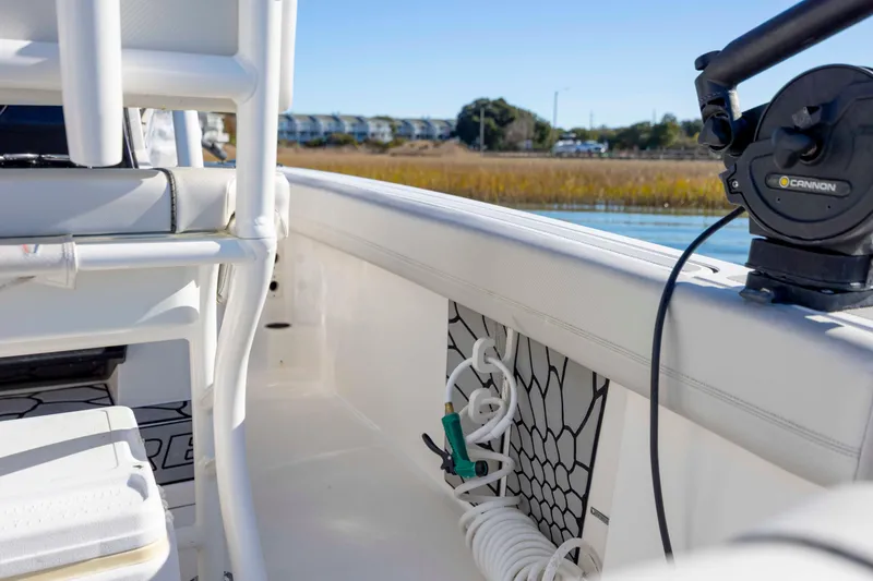 Slide: The Image of 2019 Wellcraft 222 Fisherman boat interior with fishing equipment and scenic water view. - 25