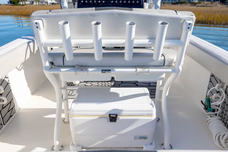 Slide: The Image of 2019 Wellcraft 222 Fisherman boat interior with rod holders and cooler. - 26