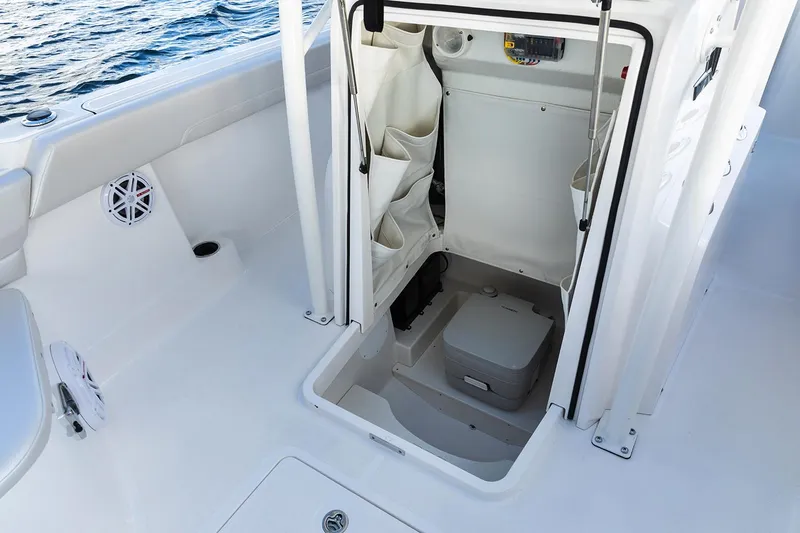Slide: The Image of Manufacturer Provided Image: 2019 Wellcraft 222 Fisherman boat interior with storage compartment and portable toilet. - 27