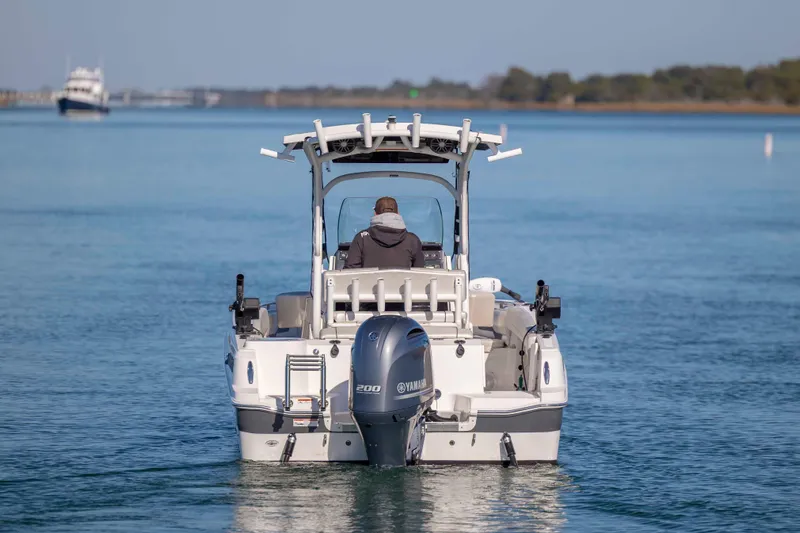 Slide: The Image of 2019 Wellcraft 222 Fisherman boat cruising on calm water. - 3