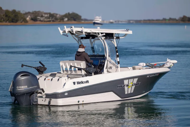 Slide: The Image of 2019 Wellcraft 222 Fisherman boat on calm water, featuring Yamaha outboard motor. - 4