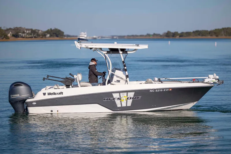 Slide: The Image of 2019 Wellcraft 222 Fisherman boat cruising on calm water with Yamaha engine. - 5