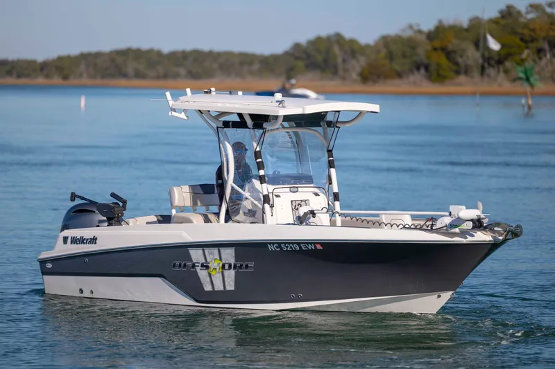 Slide: The Image of 2019 Wellcraft 222 Fisherman boat cruising on calm water, featuring sleek design and modern equipment. - 6