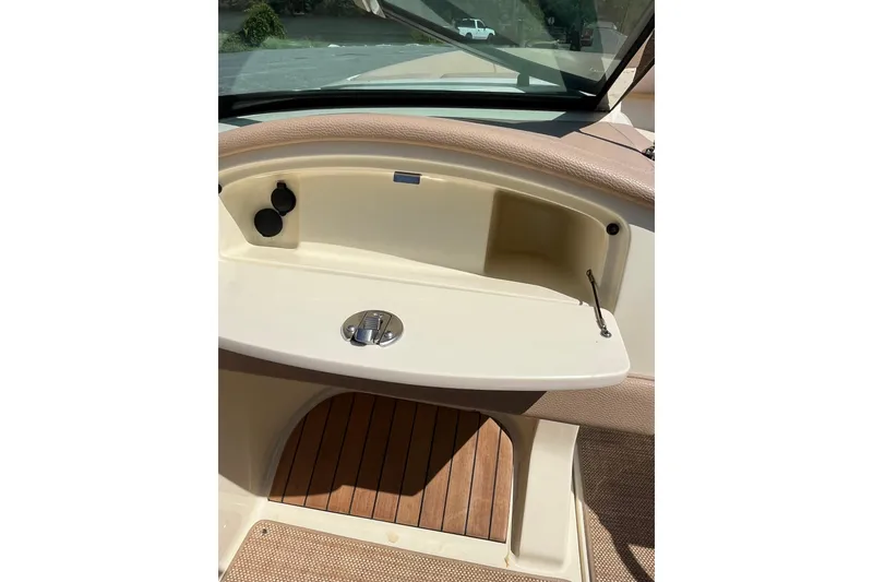 Slide: The Image of 2018 Chris-Craft Launch 23 dashboard with beige interior and wooden accents. - 13
