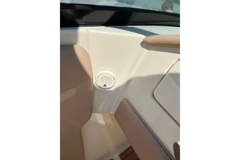 Slide: The Image of Interior detail of 2018 Chris-Craft Launch 23 boat, featuring beige upholstery and speaker. - 9