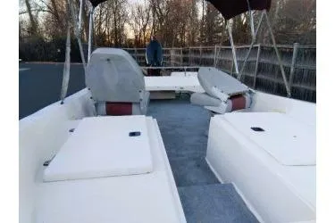 Slide: The Image of 1988 McKee Craft boat interior with seating and canopy, parked outdoors. - 5