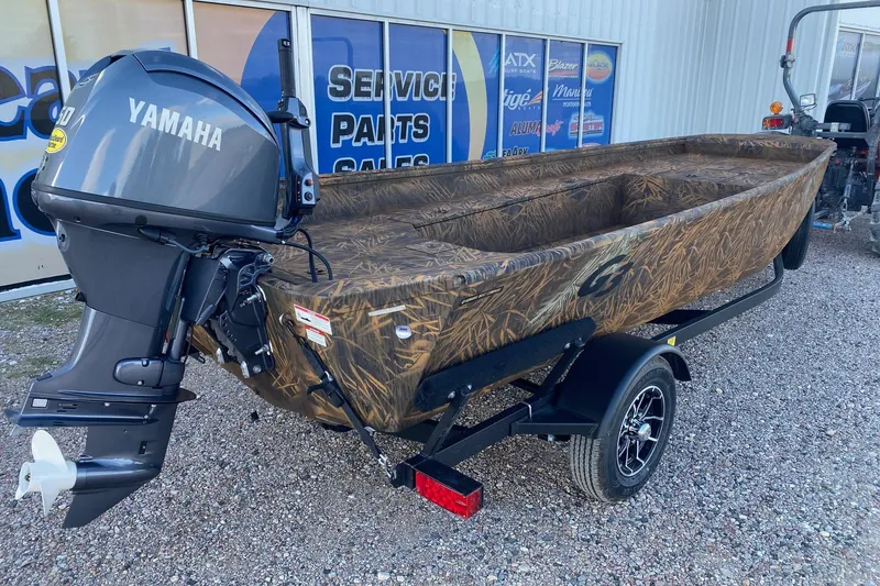Slide: The Image of 2026 G3 Gator Tough 17 DK boat with Yamaha motor, camo design, on trailer. - 5