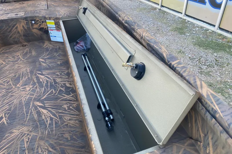 Slide: The Image of Open storage compartment in 2026 G3 Gator Tough 17 DK boat with camo interior. - 9