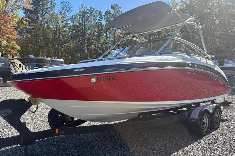 The Image of 2012 Yamaha Boats AR240 HO in vibrant red on trailer, parked outdoors. - 0