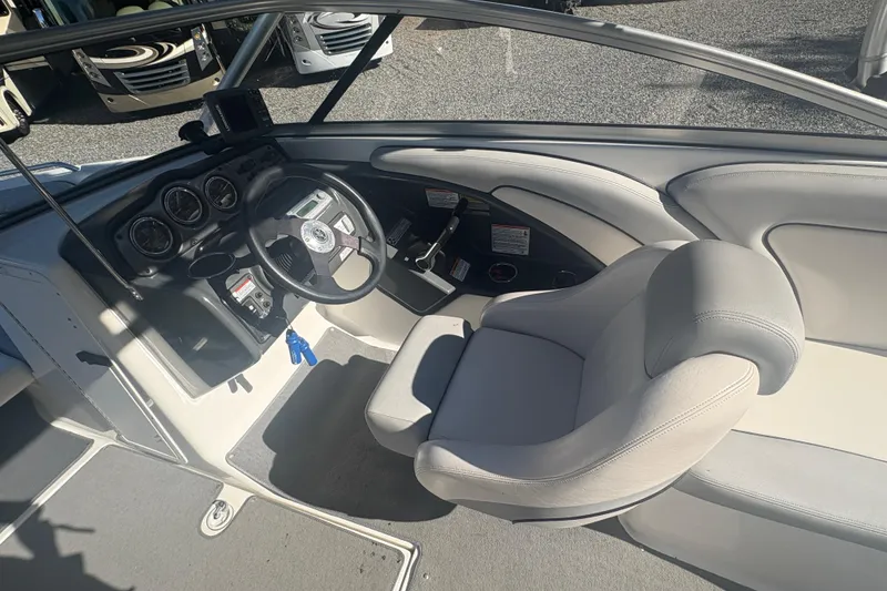 Slide: The Image of 2012 Yamaha Boats AR240 HO cockpit with steering wheel and gauges, featuring comfortable seating. - 12