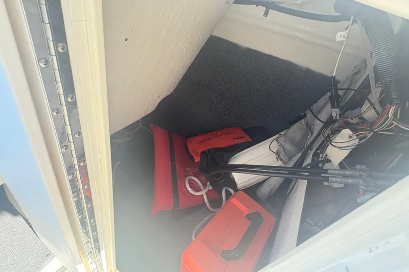 Slide: The Image of Storage compartment of 2012 Yamaha AR240 HO boat with safety gear and wiring. - 15