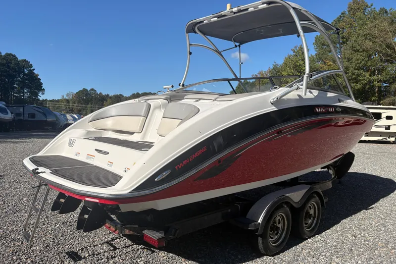Slide: The Image of 2012 Yamaha Boats AR240 HO on trailer, featuring sleek design and twin engines. - 3