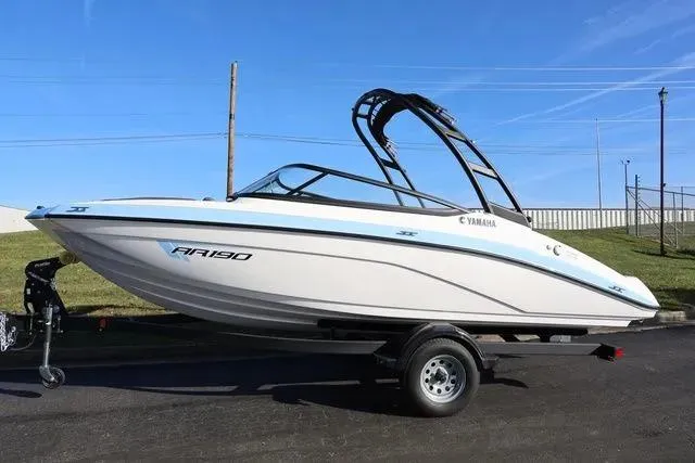 Slide: The Image of Manufacturer Provided Image: 2026 Yamaha Boats AR190, sleek white and blue design, side view with modern features. - 5