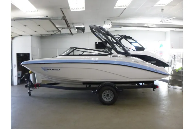 Slide: The Image of 2026 Yamaha Boats AR190 in showroom, featuring sleek design and modern amenities. - 8