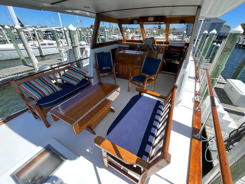 Slide: The Image of 1970 Matthews Flush Deck Cruiser with elegant wooden interior and comfortable seating at a marina. - 10