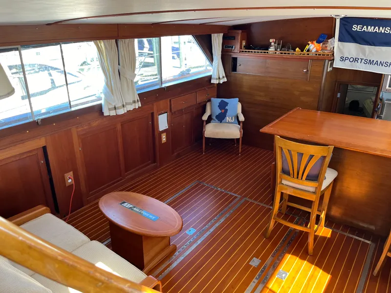Slide: The Image of 1970 Matthews Flush Deck Cruiser interior with wood paneling and nautical decor. - 20