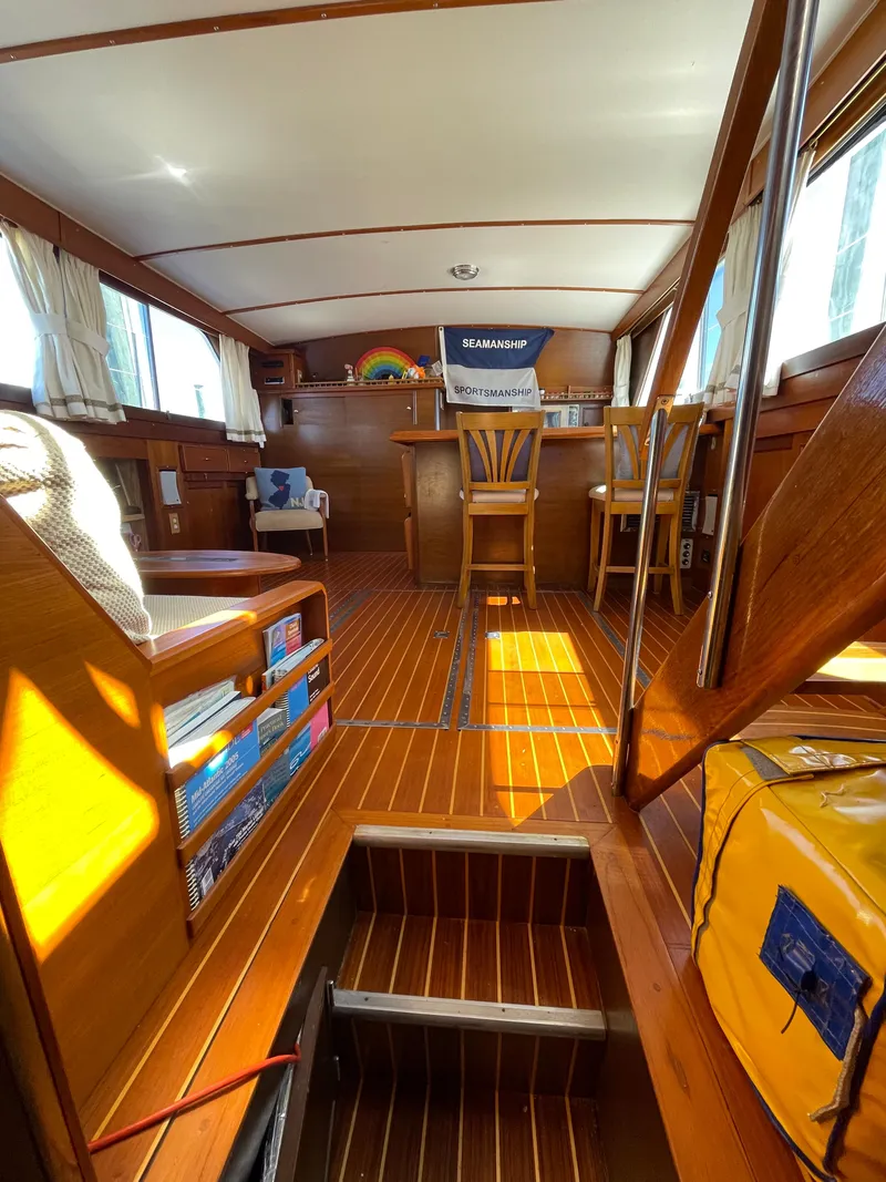 Slide: The Image of 1970 Matthews Flush Deck Cruiser interior with wooden flooring and seating area. - 24