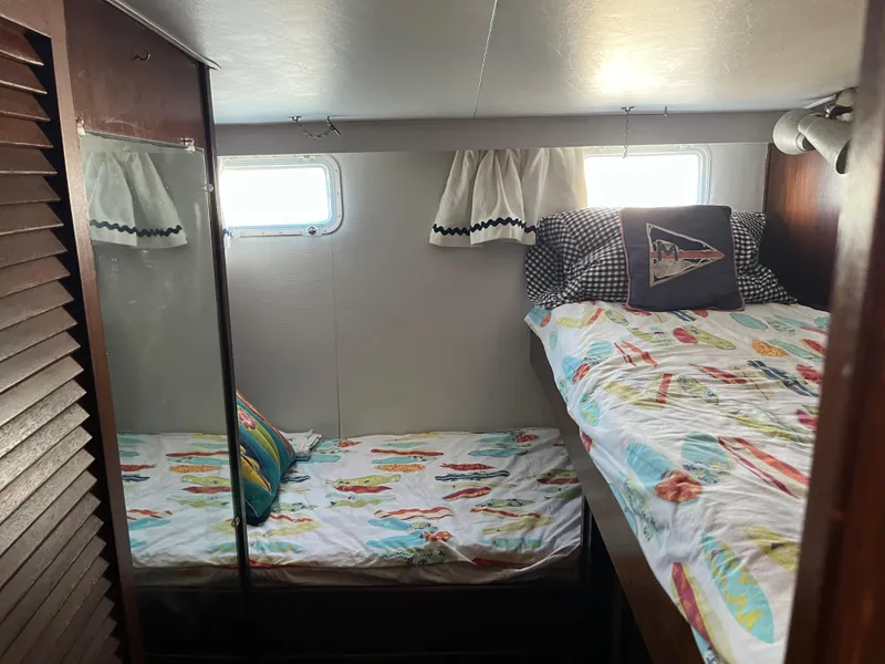 Slide: The Image of 1970 Matthews Flush Deck Cruiser cabin with twin beds and nautical-themed decor. - 32