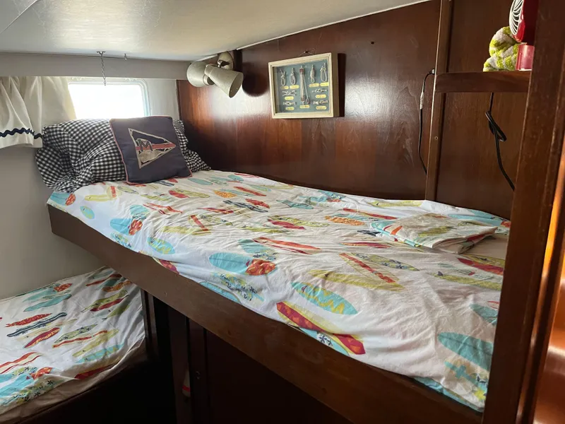 Slide: The Image of 1970 Matthews Flush Deck Cruiser cabin with bunk beds and nautical-themed decor. - 33