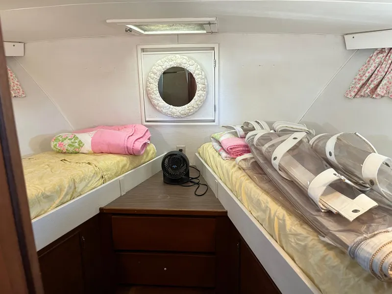 Slide: The Image of 1970 Matthews Flush Deck Cruiser cabin with twin beds and porthole window. - 36