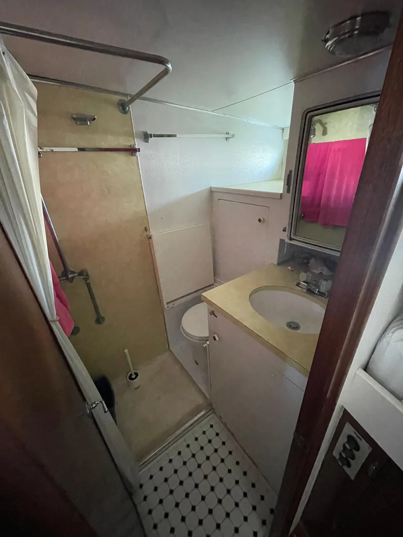 Slide: The Image of 1970 Matthews Flush Deck Cruiser bathroom with shower, sink, and window. - 37
