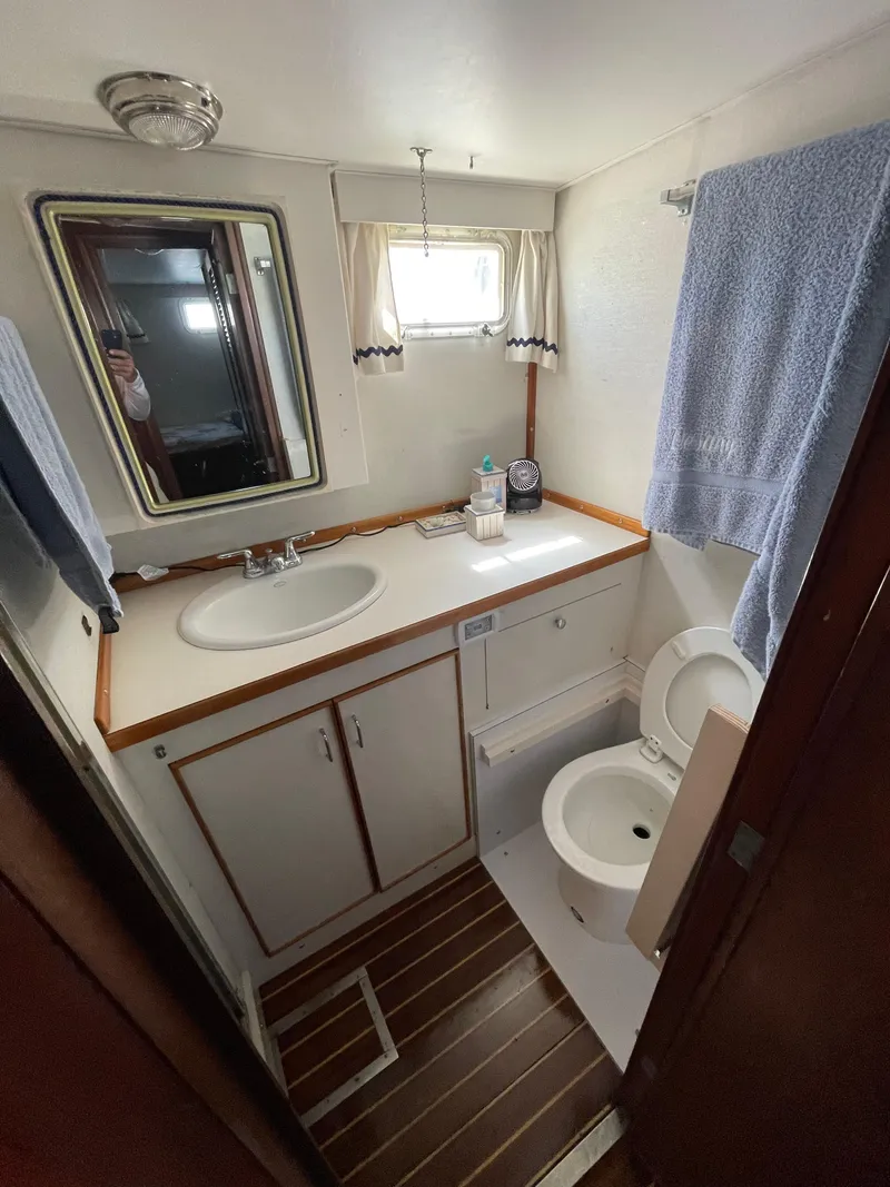 Slide: The Image of 1970 Matthews Flush Deck Cruiser bathroom with sink, mirror, and toilet. - 38