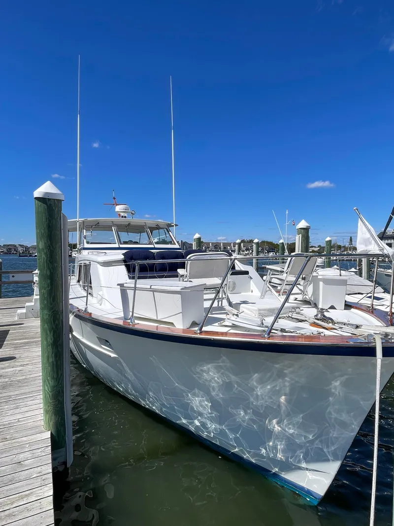 Slide: The Image of 1970 Matthews Flush Deck Cruiser docked under clear blue sky. - 4