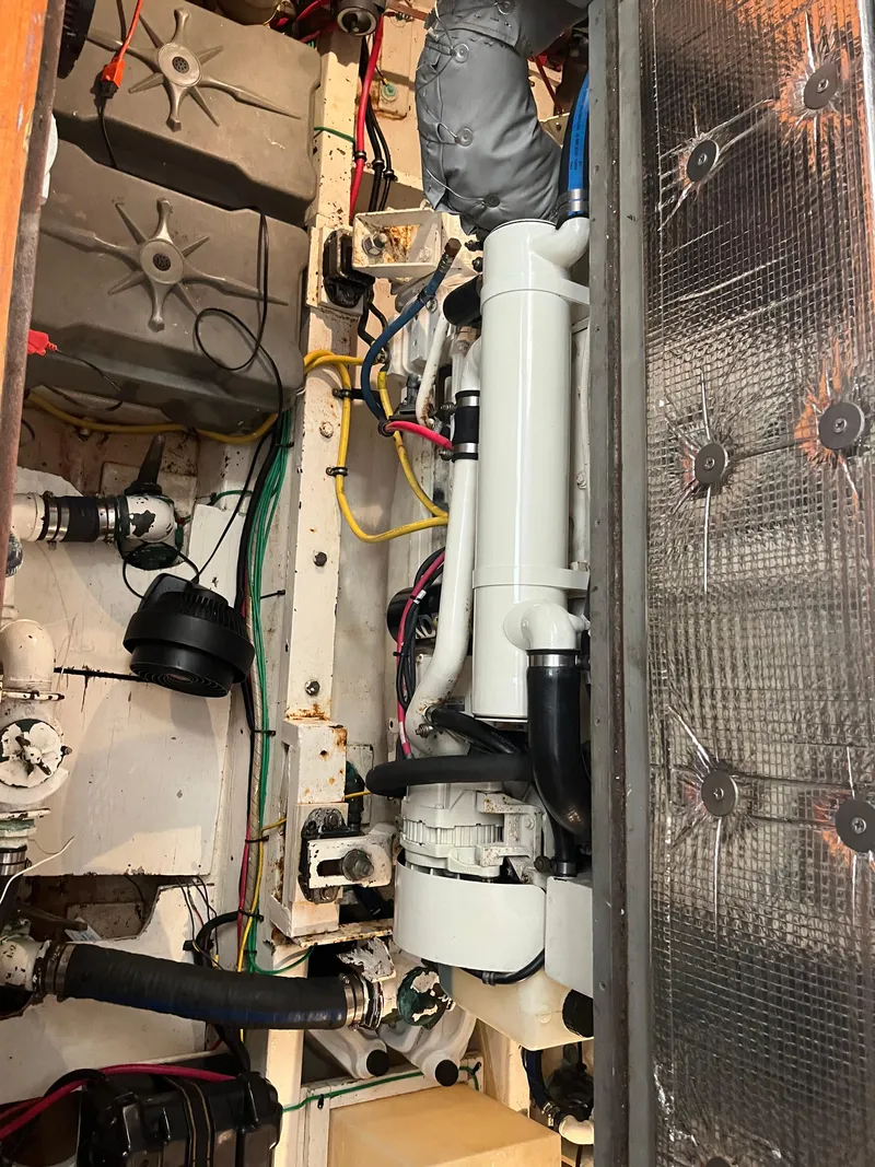 Slide: The Image of Engine room of a 1970 Matthews Flush Deck Cruiser with visible wiring and components. - 41