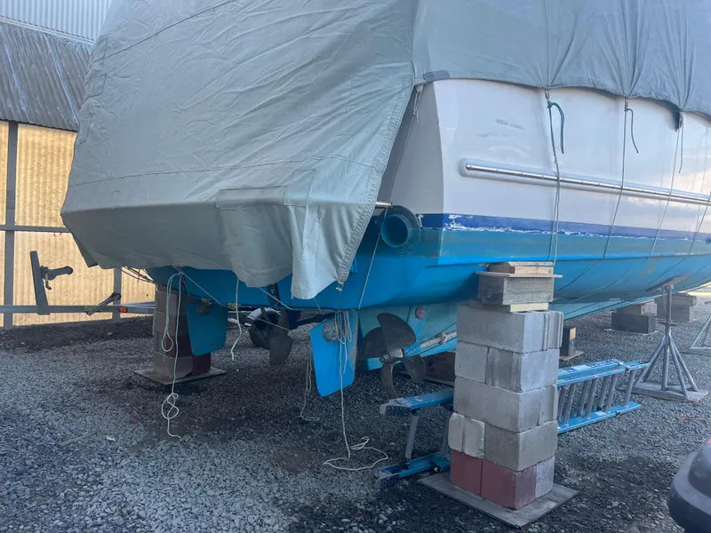 Slide: The Image of 1970 Matthews Flush Deck Cruiser covered and elevated on blocks in a boatyard. - 47