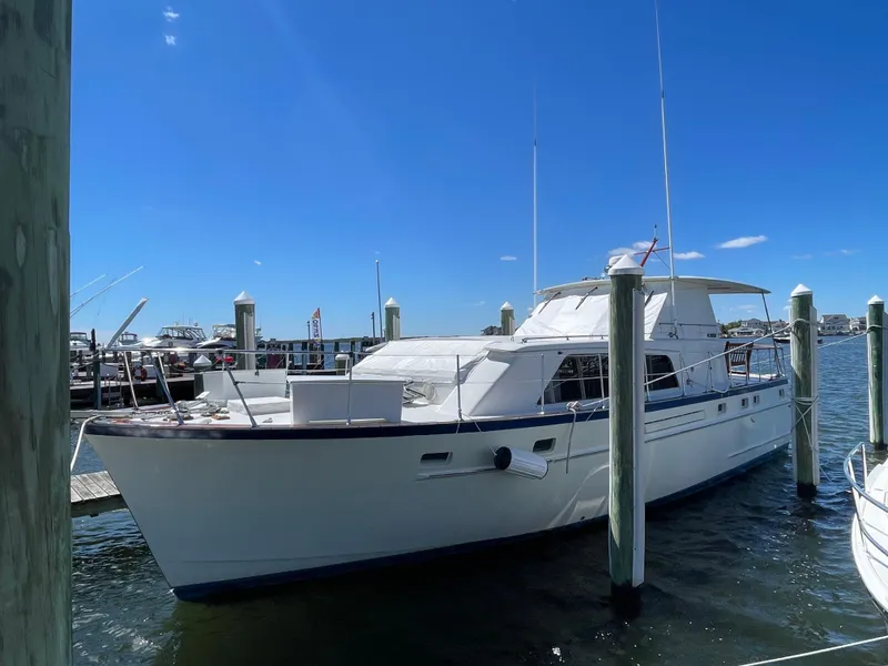 Slide: The Image of 1970 Matthews Flush Deck Cruiser docked at marina under clear blue sky. - 5