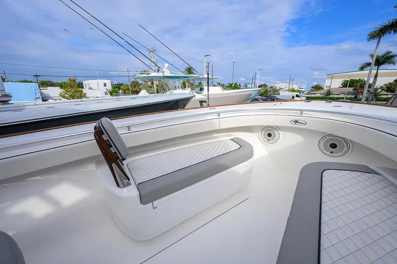 Slide: The Image of Valhalla V-33 2020 boat interior with cushioned seating and fishing rods. - 13