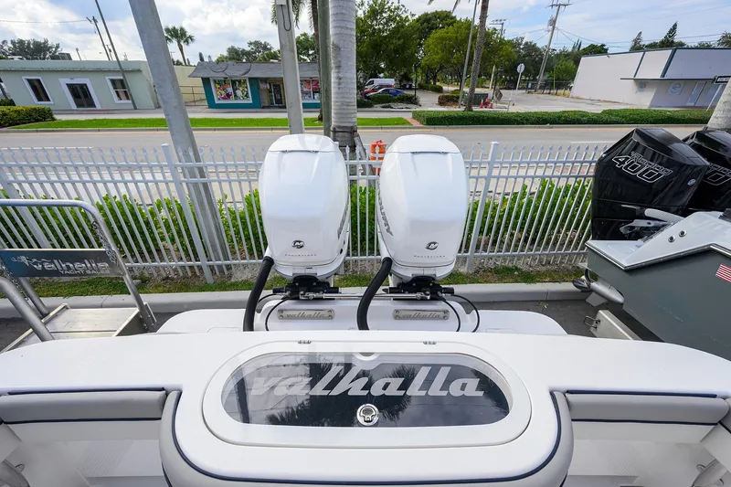 Slide: The Image of Valhalla V-33 2020 model with dual outboard engines, parked near a fence. - 23