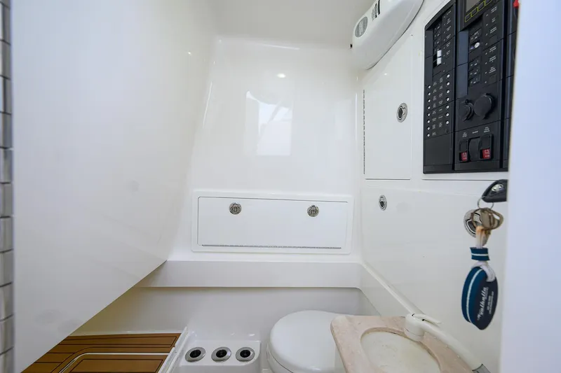 Slide: The Image of 2020 Valhalla V-33 boat interior with control panel and compact bathroom. - 26
