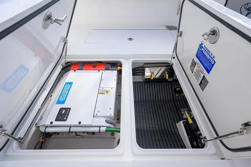 Slide: The Image of Valhalla V-33 2020 model boat compartment with electrical components and safety labels. - 30