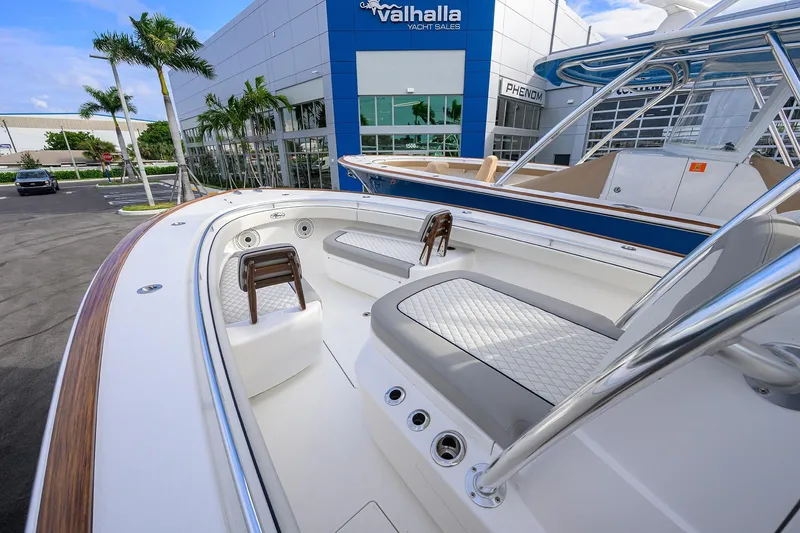 Slide: The Image of Valhalla V-33 yacht, 2020 model, at dealership with sleek design and luxurious seating. - 6