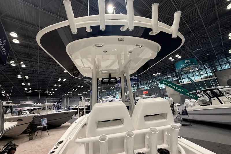 Slide: The Image of 2026 Regulator 23 boat interior at a boat show, showcasing seating and rod holders. - 10