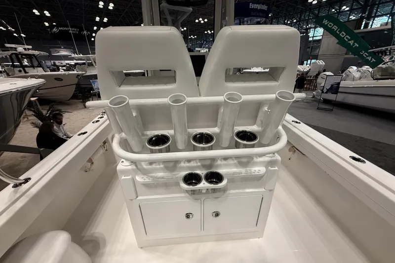 Slide: The Image of 2026 Regulator 23 boat interior with rod holders and storage compartments at a boat show. - 16
