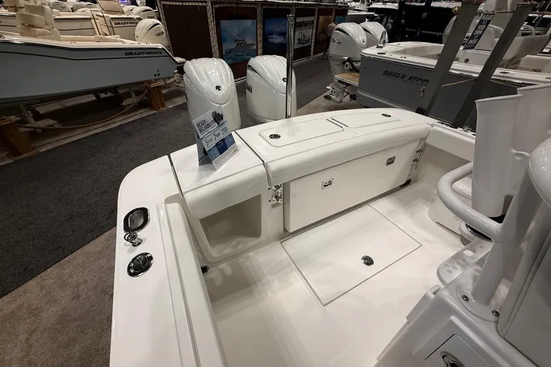 Slide: The Image of 2026 Regulator 23 boat interior at a showroom, showcasing seating and storage features. - 19
