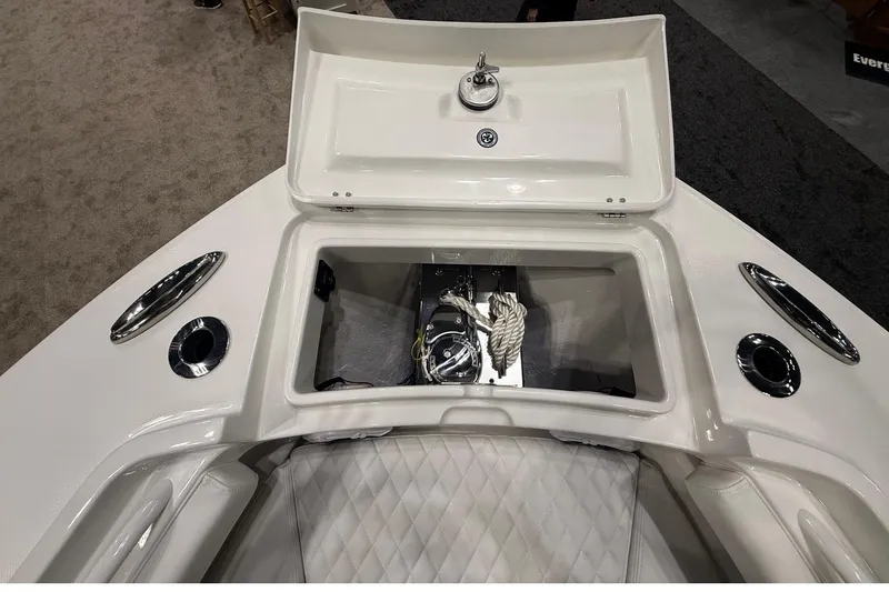 Slide: The Image of Regulator 23 boat 2026 with open storage compartment and rope. - 25