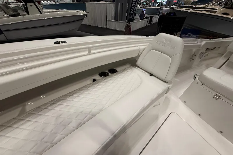 Slide: The Image of 2026 Regulator 23 boat interior with white cushioned seating and sleek design. - 26