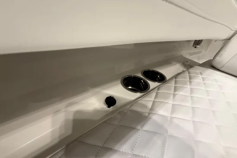Slide: The Image of 2026 Regulator 23 boat interior with quilted seating and cup holders. - 27