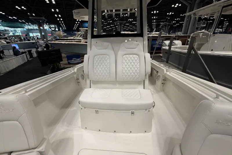 Slide: The Image of 2026 Regulator 23 boat interior with white seating at a boat show. - 29