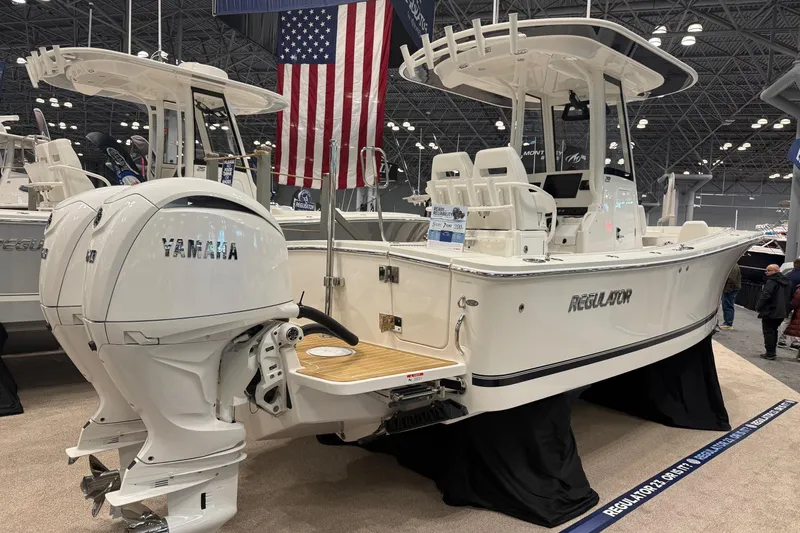 Slide: The Image of 2026 Regulator 23 boat with Yamaha engines displayed at a boat show. - 3