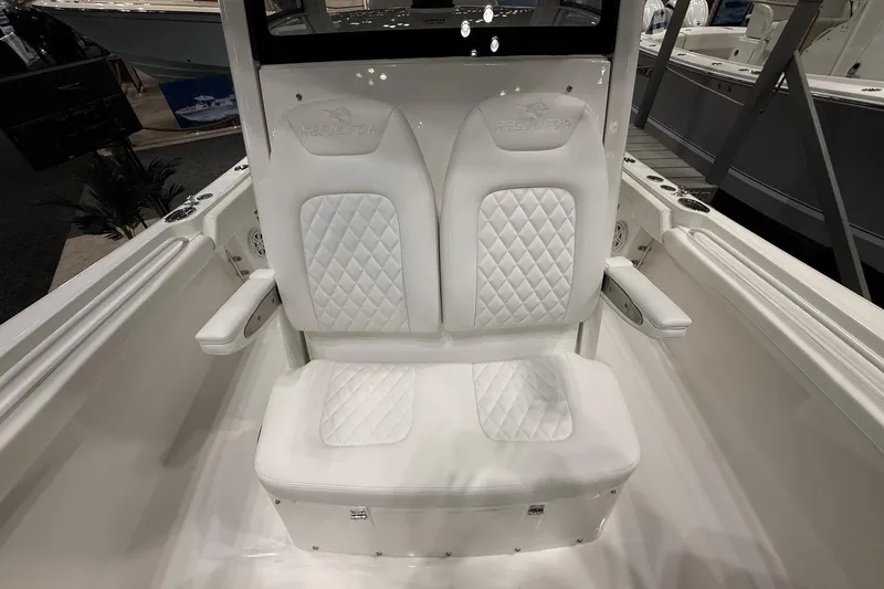 Slide: The Image of 2026 Regulator 23 boat interior with white quilted seating and armrests. - 31