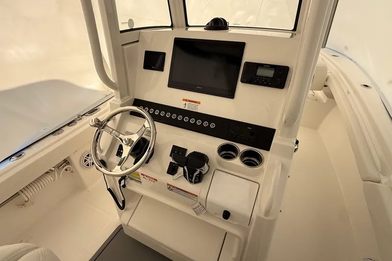 Slide: The Image of 2026 Regulator 23 boat dashboard with steering wheel, controls, and navigation display. - 35